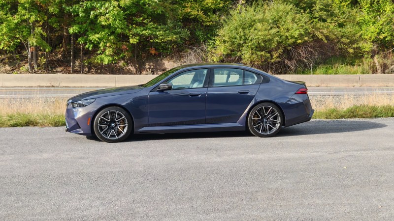 Side view of a a 2025 BMW M5 in the countryside