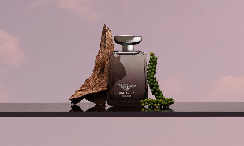Bentley Become Zenith fragrance bottle balanced on a shelf with a purple sky background.