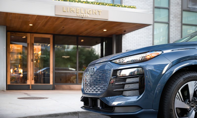 Gray Audi SUV parked in front of Boulder Limelight hotel entrance.