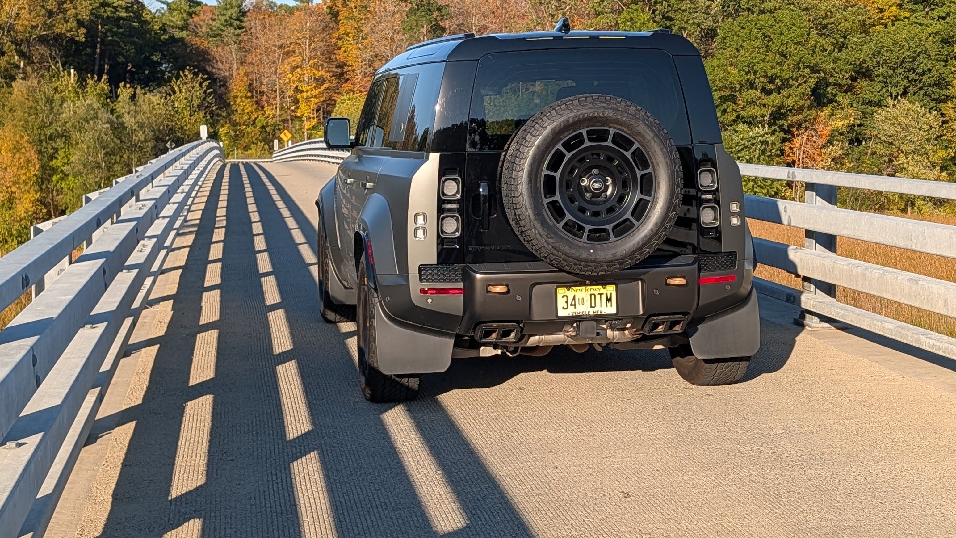 Rear view of a 2025 Land Rover Defender 110 OCTA on a bridge