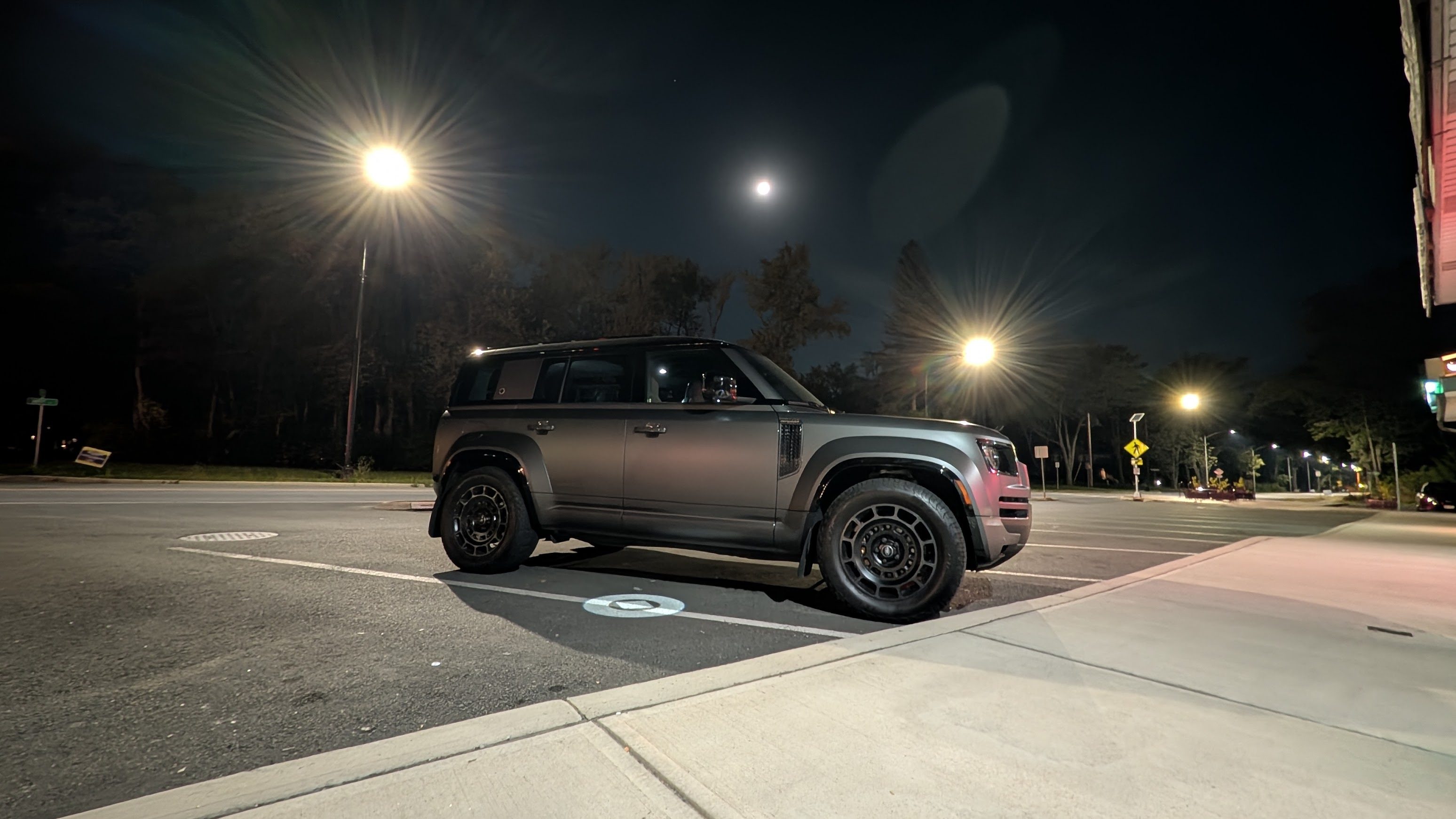 Side view of a 2025 Land Rover Defender 110 OCTA at night